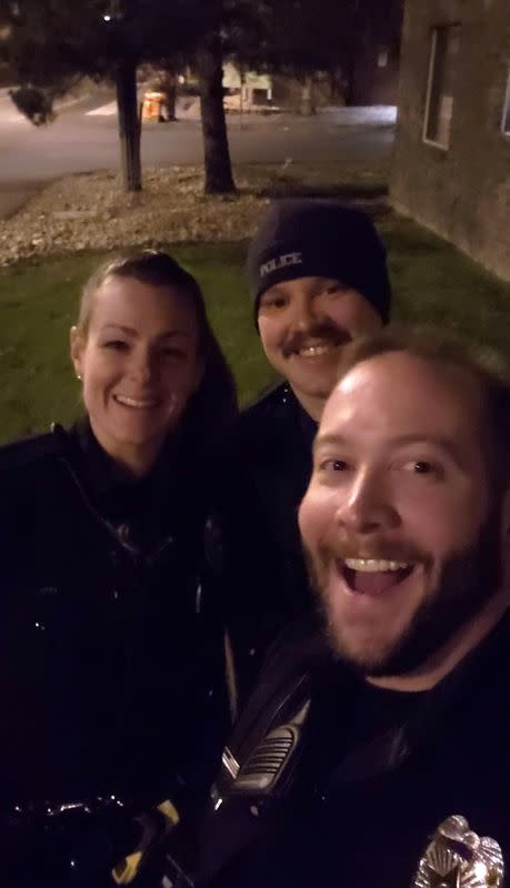 Aurora Police officers reenact a chokehold near a memorial to Elijah McClain