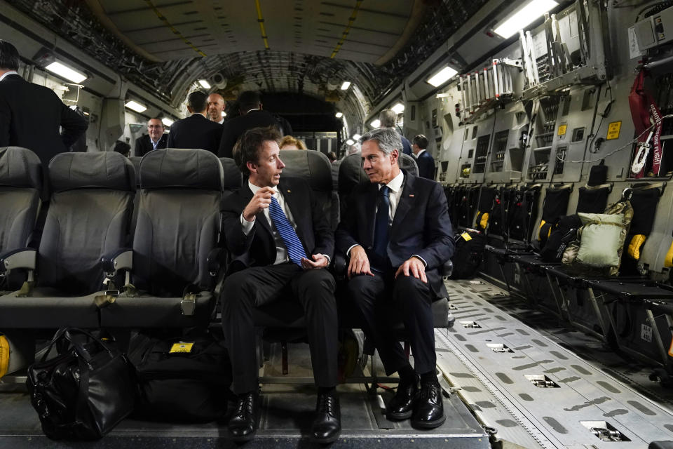 FILE - Secretary of State Antony Blinken speaks with Tom Sullivan, deputy chief of staff for policy, seated left, on a C-17 aircraft and they depart Tel Aviv, Oct. 12, 2023, en route to Jordan. AP Washington photographer Jacquelyn Martin recalls how being one of a few female photographers covering news and politics was useful when she was assigned as the press pooler for Blinken's last-minute trip to Israel and the Middle East in the aftermath of the Hamas attacks. Martin said, “Sometimes people not knowing what to make of you works in your favor.” (AP Photo/Jacquelyn Martin, Pool, File)