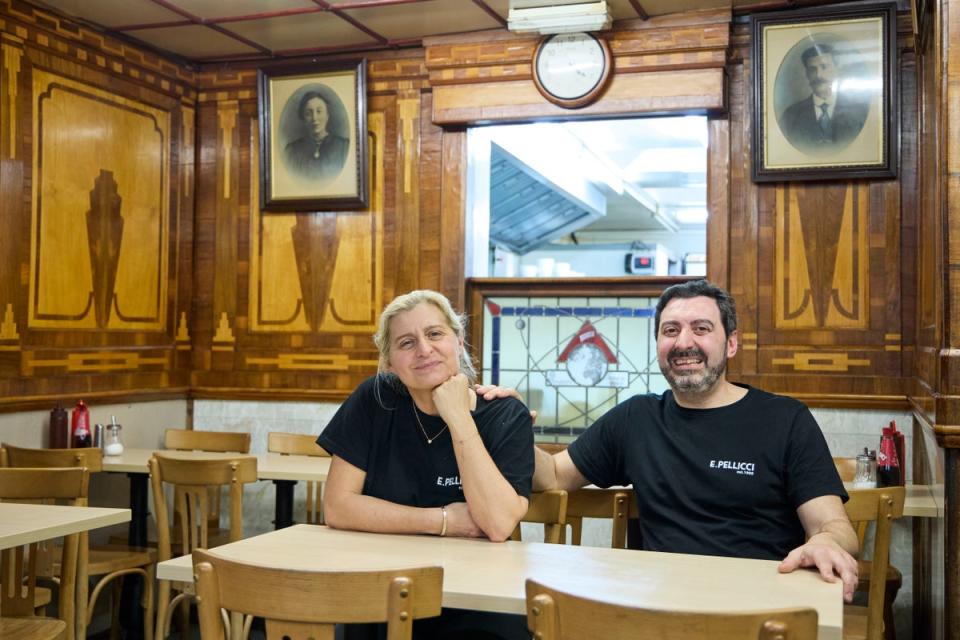 Anna and Nev, with pictures of their grandparents behind them (Matt Writtle)