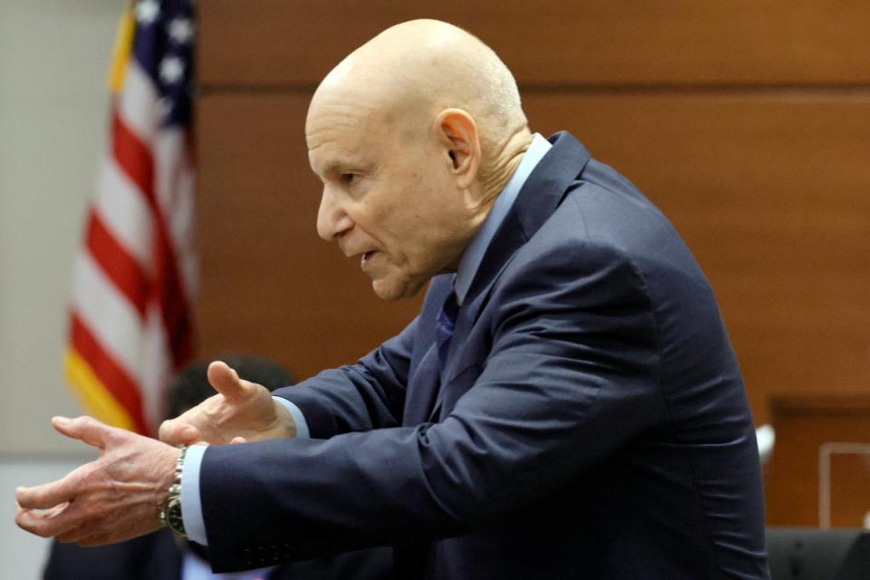 Prosecutor Mike Satz gestures as if he is holding a rifle during his closing argument (© South Florida Sun Sentinel 2022)