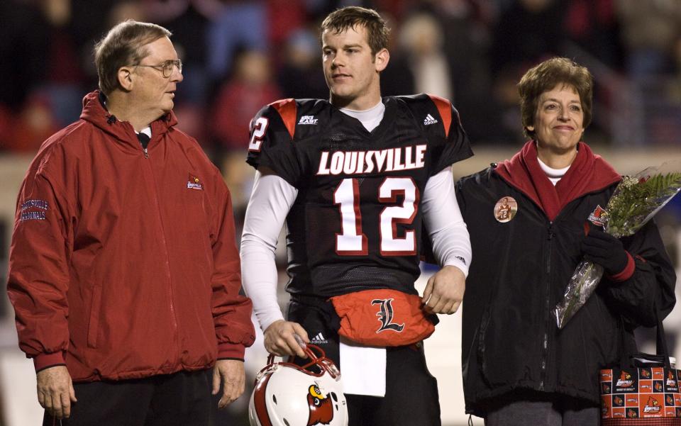 Brian Brohm stands with father, Oscar, and mother, Donna, on the field as the seniors were honored.