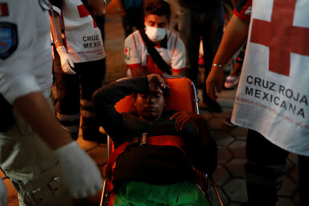 Eight months pregnant Honduran migrant Erly Marcial, 21, is carried to a hospital on a stretcher in Puebla, Mexico, November 11, 2018. REUTERS/Carlos Garcia Rawlins