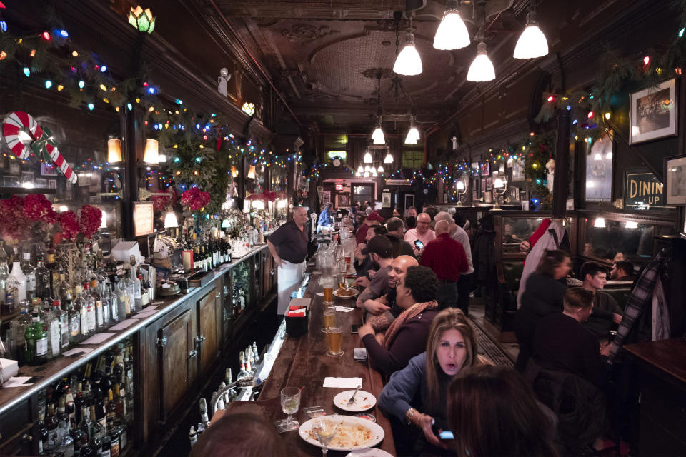 FILE - In this Dec. 27, 2019, file photo, customers mingle in New York's Old Town Bar. With New York City at the epicenter of the coronavirus outbreak in the U.S. and its native-born among those offering crucial information to the nation in televised briefings, the New York accent has stepped up to the mic. (AP Photo/Mark Lennihan, File)