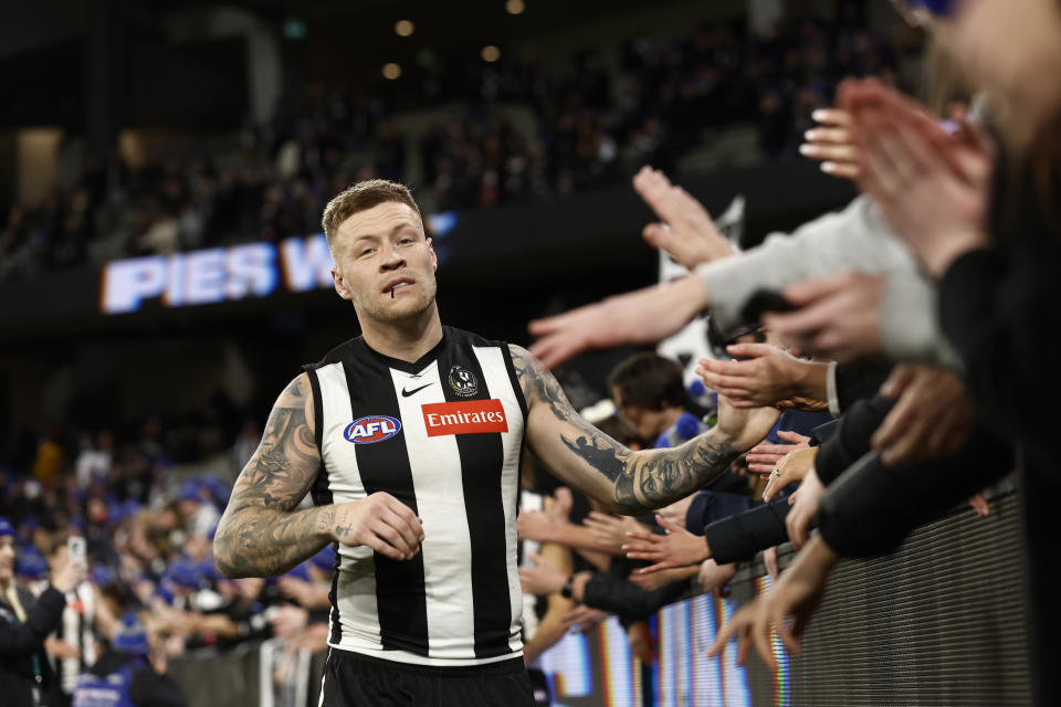 Jordan de Goey, pictured here celebrating with Collingwood fans after their win over Melbourne.