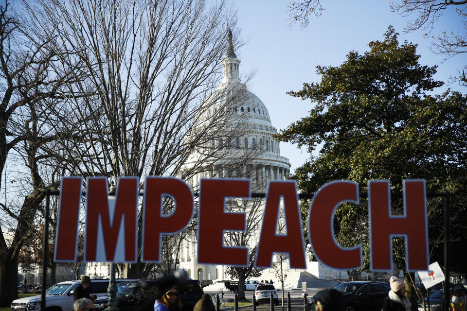 Protesters demonstrate as the House of Representatives begins debate on the articles of impeachment against President Donald Trump at the U.S. Capitol building, Wednesday, Dec. 18, 2019, on Capitol Hill in Washington. (AP Photo/Matt Rourke)