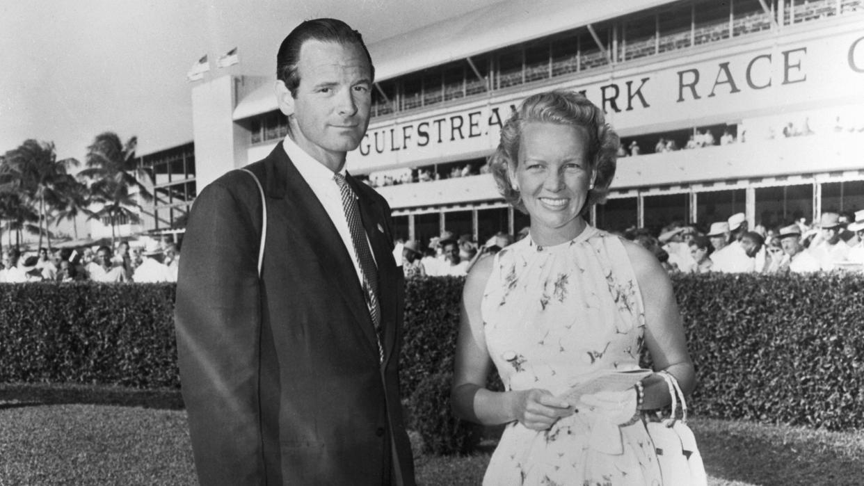 ann woodward standing next to her husband billy woodward in a photo at a horse racing track