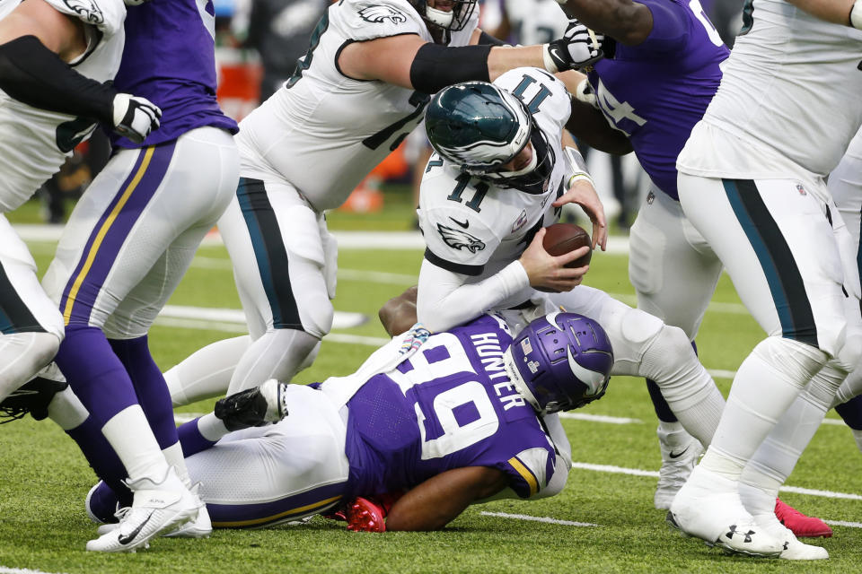 Philadelphia Eagles quarterback Carson Wentz (11) is sacked by Minnesota Vikings defensive end Danielle Hunter (99) during the second half of an NFL football game, Sunday, Oct. 13, 2019, in Minneapolis. (AP Photo/Bruce Kluckhohn)