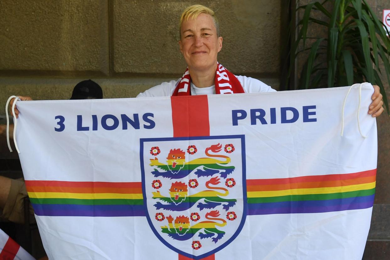 England fan and LGBT+ rights campaigner Di Cunningham displays a rainbow flag before England's first World Cup match: AFP/Getty Images