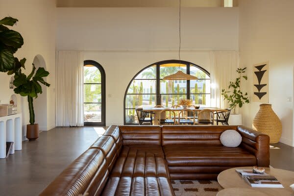 In order to achieve ample daylighting, artful windows were imperative—but all that light can also come with lots of heat. Thick glass and overhanging arches were key to the design scheme so that the home was insulated from the harsh Arizona climate. The main living area also features a 20-foot tongue-and-groove ceiling that extends to both patios.