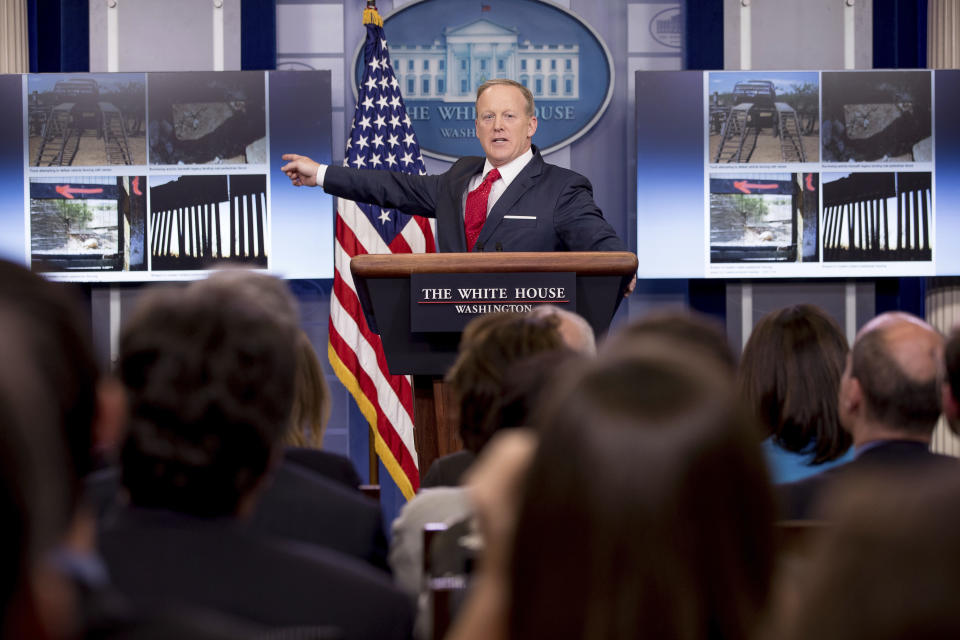 Images depicting sections of different kinds of border walls are displayed behind Trump White House press secretary Sean Spicer as he talks to the media during the daily press briefing, May 3, 2017. (Photo: Andrew Harnik/AP)