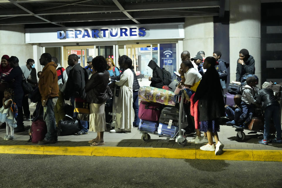 FILE- Zimbabwean evacuees from Sudan arrive at the Robert Mugabe International airport in Harare, Zimbabwe, Friday, April, 28, 2023. Zimbabwe received its first batch of 42 evacuees from Sudan, Friday according to the countries authorities. Many Africans escaping the conflict in Sudan that erupted with little warning last month faced a long wait - three weeks for some - to get out and severe challenges on the way as their governments stuggled to mobilize resources.(AP Photo/Tsvangirayi Mukwazhi, File)