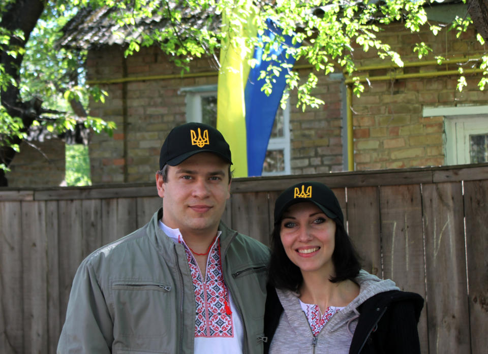 FILE - In this April. 25, 2014 file photo, Natalia Snihur, 35, and her husband Yehor Korniyev, 35, pose for a photo in front of their home in Kiev, Ukraine, months after they protested with many others to help overthrow what they consider a corrupt, hardline pro-Russian president and bring a new pro-Western government to power. Like many Ukrainians, Snihur and Korniyev are still proud of the popular uprising and hopeful that their country will turn into a dignified European nation, “Ukraine is being born, it is in labor now, it is giving birth to a nation that will have a conscious national identity,” Snihur said during an interview in her family kitchen. (AP Photo/ Maria Danilova, File)