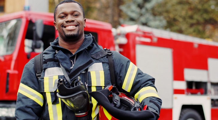 Fireman standing in front of fire truck.