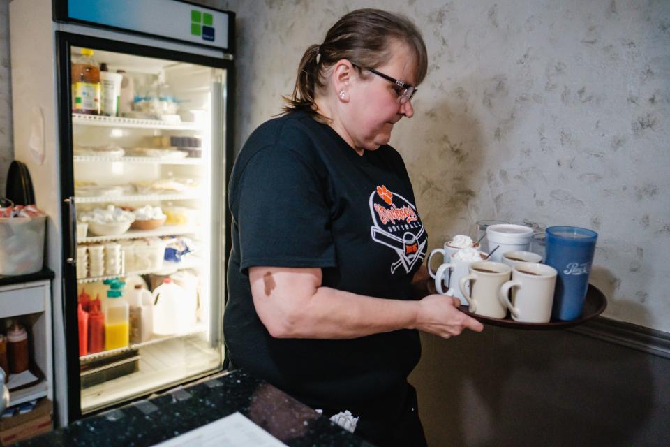 Server Mary Beth Christner takes drinks to a table at Rosalie's Restaurant in Strasburg.