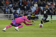 Vancouver Whitecaps goalkeeper Yohei Takaoka (18) makes a save as Minnesota United forward Cameron Dunbar (23) runs by in the second half of an MLS soccer game Saturday, March 25, 2023, in St. Paul, Minn. (AP Photo/Andy Clayton-King)