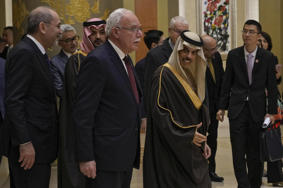 Saudi Arabia's Foreign Minister Faisal bin Farhan Al Saud, left, chats with Palestine Foreign Minister Riyad al-Maliki and Jordanian Deputy Prime Minister and Foreign Minister Ayman Safadi as they arrive to the Diaoyutai state guesthouse to meet with their Chinese Counterpart Wang Yi, in Beijing, Monday, Nov. 20, 2023. China's foreign minister welcomed five Arab and Islamic counterparts to Beijing on Monday, saying his country would work with "our brothers and sisters" in the Arab and Islamic world to try to end the fighting in Gaza as soon as possible. (AP Photo/Andy Wong)