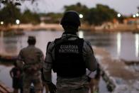 Members of the National Guard keep watch at the banks of the Suchiate river, while they guard the border to prevent a migrant caravan of Central Americans from entering, in Ciudad Hidalgo