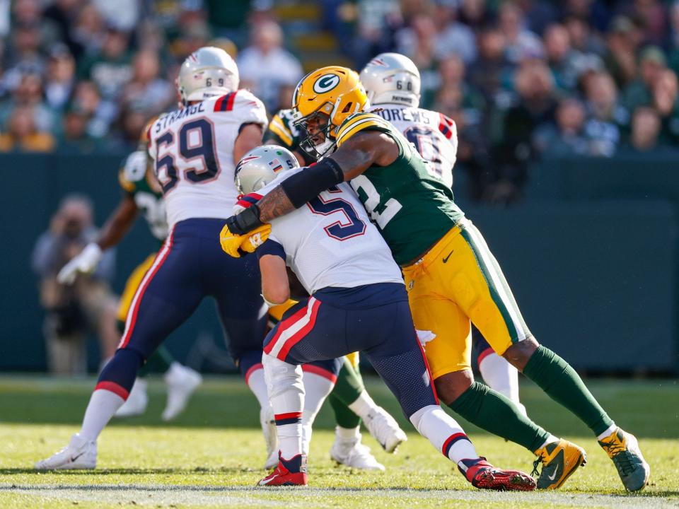 Rashan Gary records a sack against the New England Patriots.