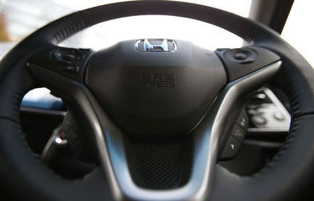 An airbag logo is seen on a steering wheel of Honda Motor Co's all-new hybrid sedan "Grace", which installed the airbag made by Takata Corp, during its unveiling event in Tokyo December 1, 2014. REUTERS/Toru Hanai