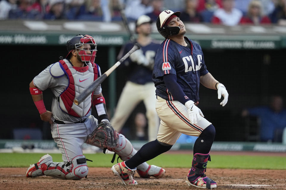 Cleveland Guardians' Josh Naylor drops his bat in front of Washington Nationals catcher Keibert Ruiz, left, as he flies out during the fifth inning of a baseball game Friday, May 31, 2024, in Cleveland. (AP Photo/Sue Ogrocki)