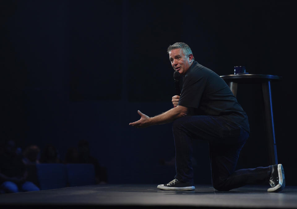 Lead pastor Jeff Leake of Allison Park Church kneels while giving his sermon on Sunday, Nov. 6, 2022, in Allison Park, Pa. Leake began his message by encouraging his congregation to head to the polls on Tuesday for the midterm elections. (AP Photo/Jessie Wardarski)