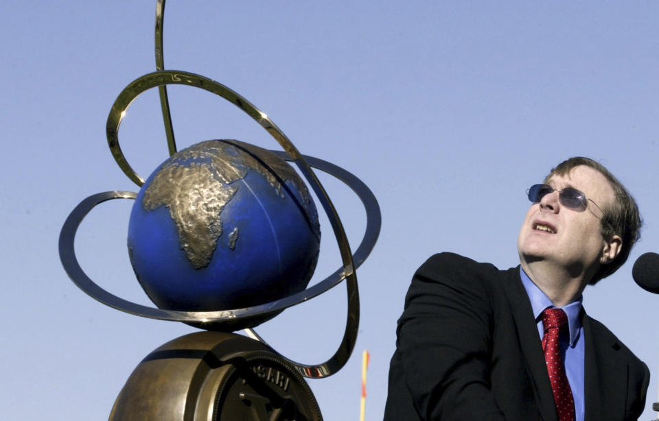 FILE- In this Nov. 6, 2004, file photo, Paul Allen, chairman of Charter Communications and co-founder of Microsoft looks in the air while making remarks during the ceremonies and presentation of the $ 10 million check and the trophy, on the left, to Scaled Composites as part of the Ansari X Prize. Prior to his death on Monday, Oct. 15, 2018, Allen invested large sums in technology ventures, research projects and philanthropies, some of them eclectic and highly speculative. Outside of bland assurances from his investment company, no one seems quite sure what happens now. (AP Photo/James A. Finley, File)