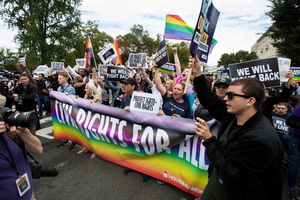 In this Oct. 8, 2019 file photo, supporters of LGBTQ rights stage a protest on the street in front of the U.S. Supreme Court in Washington.