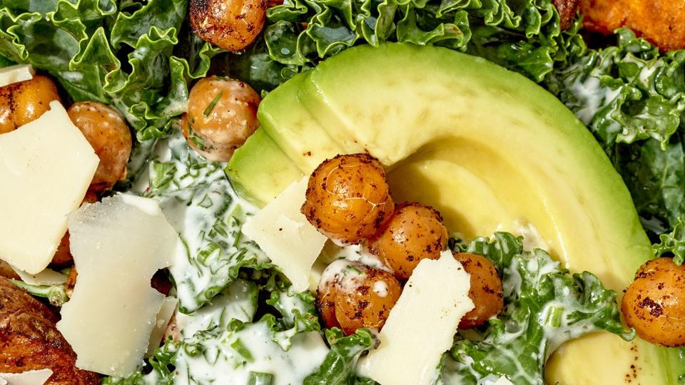 closeup of vegan kale salad with crunchy chickpeas, sweet potatoes, and avocado