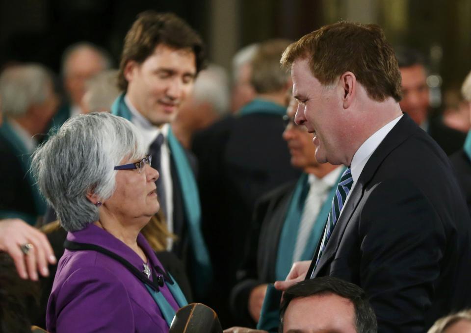 Canada's Minister of Foreign Affairs John Baird talks with former minister Bev Oda as they arrive for the state funeral of Canada's former finance minister Jim Flaherty in Toronto