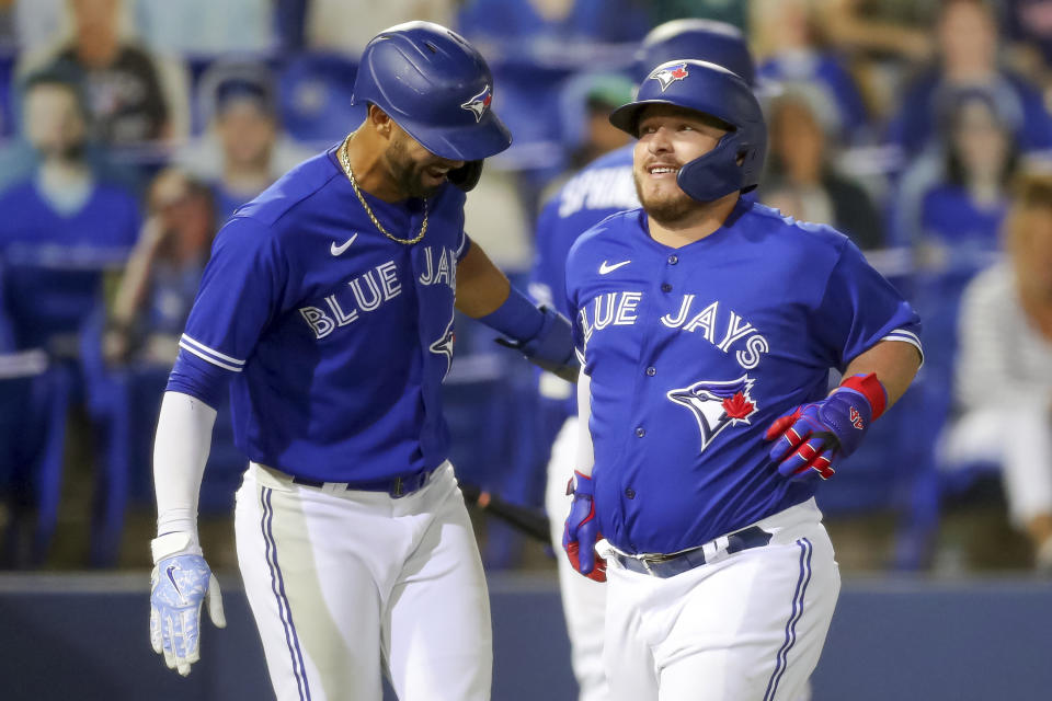 Toronto Blue Jays' Alejandro Kirk, right, is congratulated by Lourdes Gurriel Jr. after his two-run home run scored them against the Atlanta Braves during the fourth inning of a baseball game Friday, April 30, 2021, in Dunedin, Fla. (AP Photo/Mike Carlson)