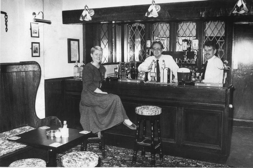 Alan Clarke, (centre) manager of the newly refurbished Grapes Public House in Mathew Street, Liverpool, L2.  He is pictured with his wife Ann and barman Bernie Sharkey. Picture taken 13th December 1989