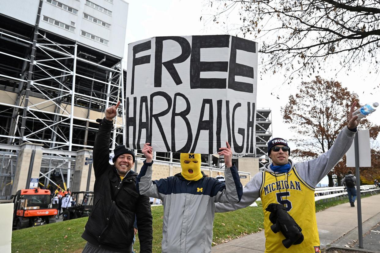Fans display a sign about Michigan coach Jim Harbaugh before Saturday's game at Penn State.