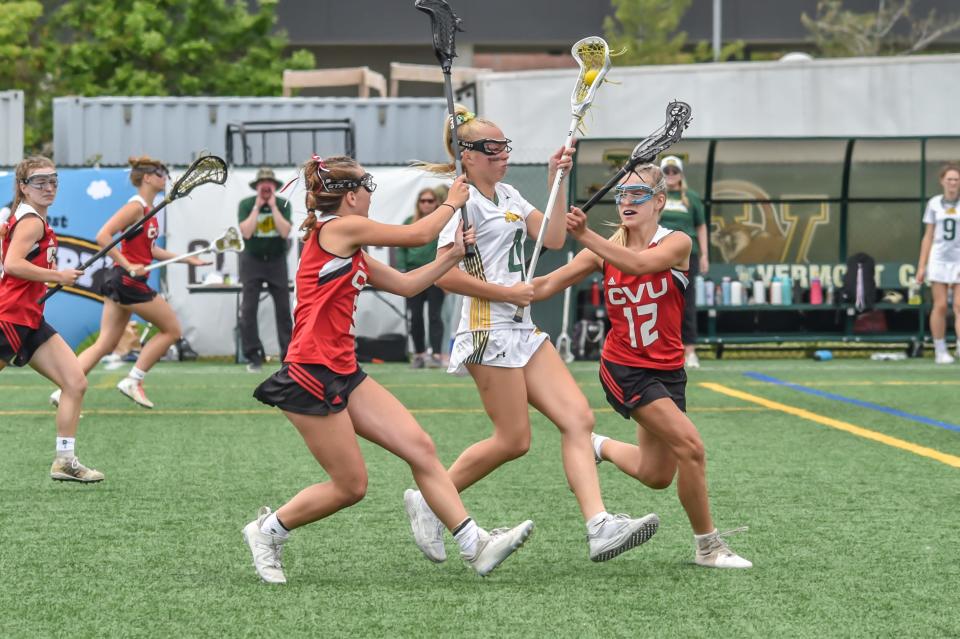 Burr and Burton's Mai-Liis Edwards splits a CVU Marlie Cartwright-Emerson Rice double team during the Bulldogs' 15-14 D-l Championship extra time win over the Redhawks last year.