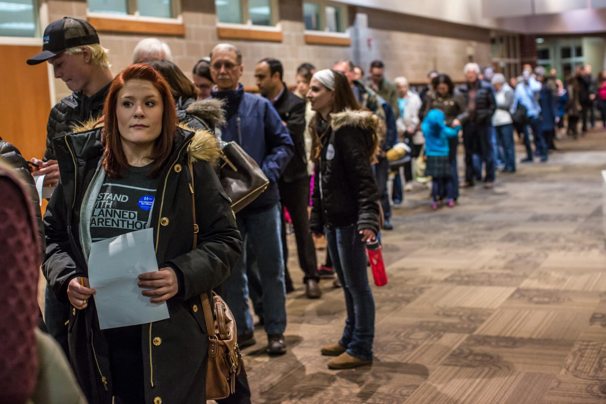 Democratic caucusgoers wait on line to caucus in West Des Moines, Iowa, on Feb. 1, 2016. 