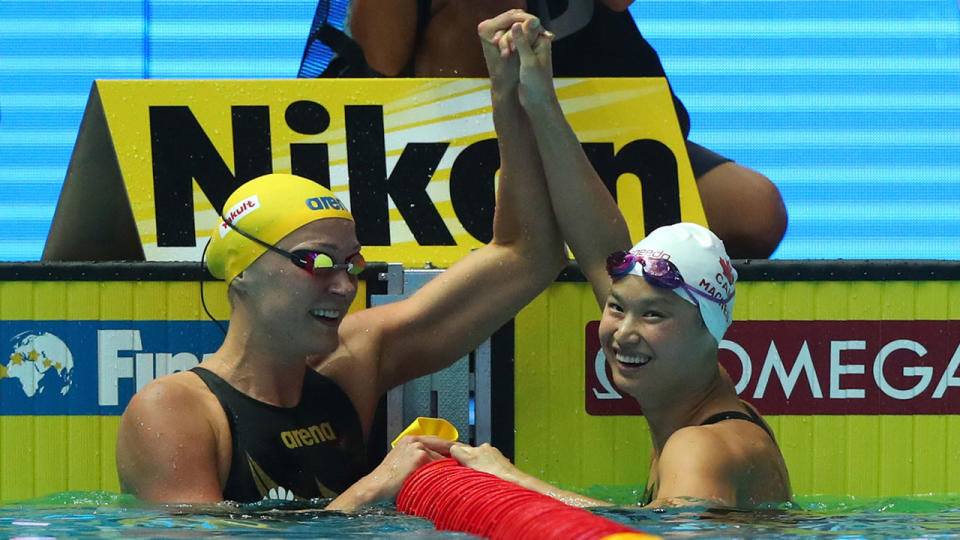 Sarah Sjostrom lifts the arm of gold medallist Margaret MacNeil in celebration. Pic: Getty