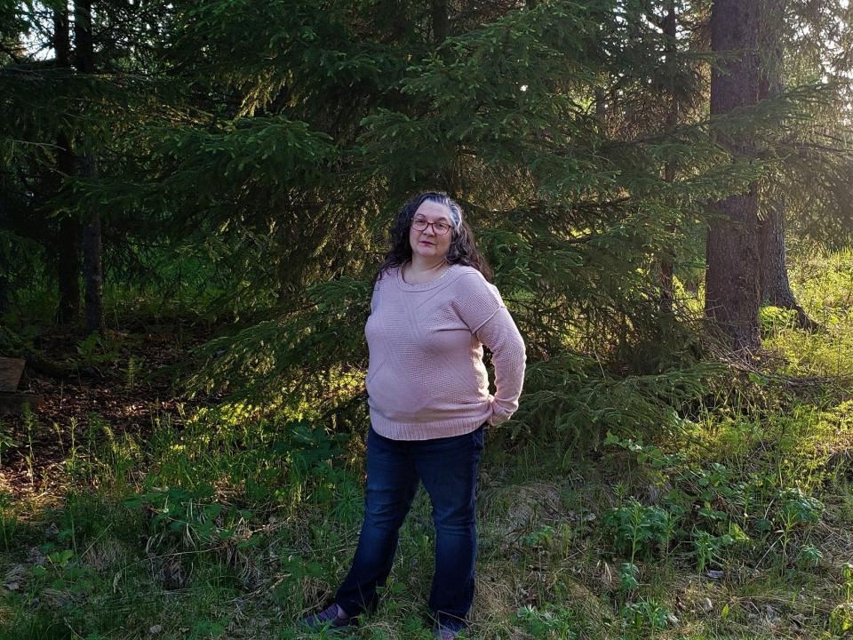 Nicole standing on front of a green forest