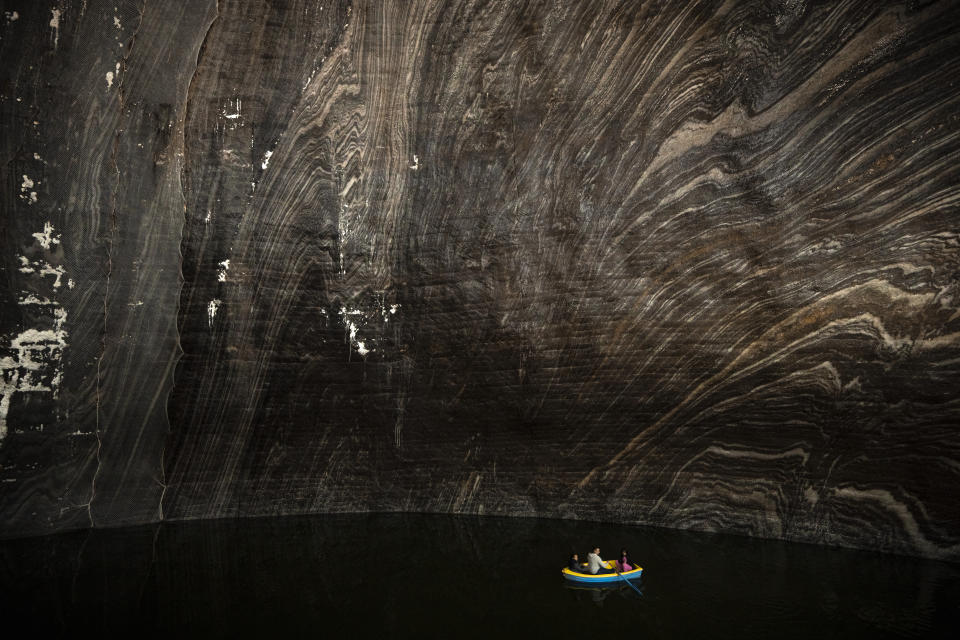 Tourists sit in a boat at an underground lake at the Salina Turda, a former salt mine turned touristic attraction, now listed by emergency authorities as a potential civil defense shelter in Turda, central Romania, Monday, Oct. 17, 2022. Fighting around Ukraine's nuclear power plants and Russia's threats to use nuclear weapons have reawakened nuclear fears in Europe. This is especially felt in countries near Ukraine, like Poland, where the government this month ordered an inventory of the country's shelters as a precaution. (AP Photo/Vadim Ghirda)