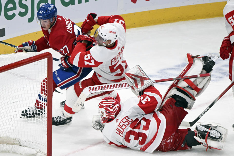 Montreal Canadiens' Gustav Lindstrom (27) scores against Detroit Red Wings goaltender Ville Husso as Red Wings' David Perron (57) defends during the third period of an NHL hockey game, Saturday, Dec. 2, 2023 in Montreal. (Graham Hughes/The Canadian Press via AP)