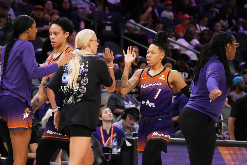 Phoenix Mercury guard Sug Sutton, right, is greeted by teammate Sophie Cunningham during a timeout against the Washington Mystics in their September 5, 2023 game in Phoenix. Sutton is one of three forrmer Longhorns who are on WNBA rosters for Tuesday night's season openers.