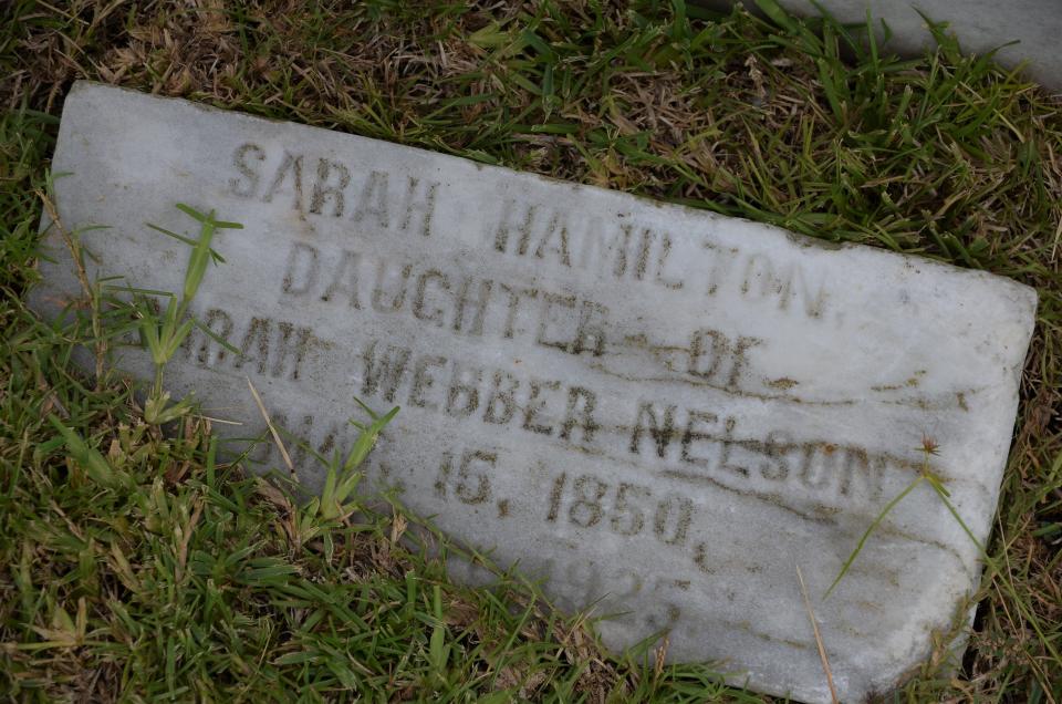 A headstone marks the final resting place of Sarah Hamilton, who was born in May of 1850.
