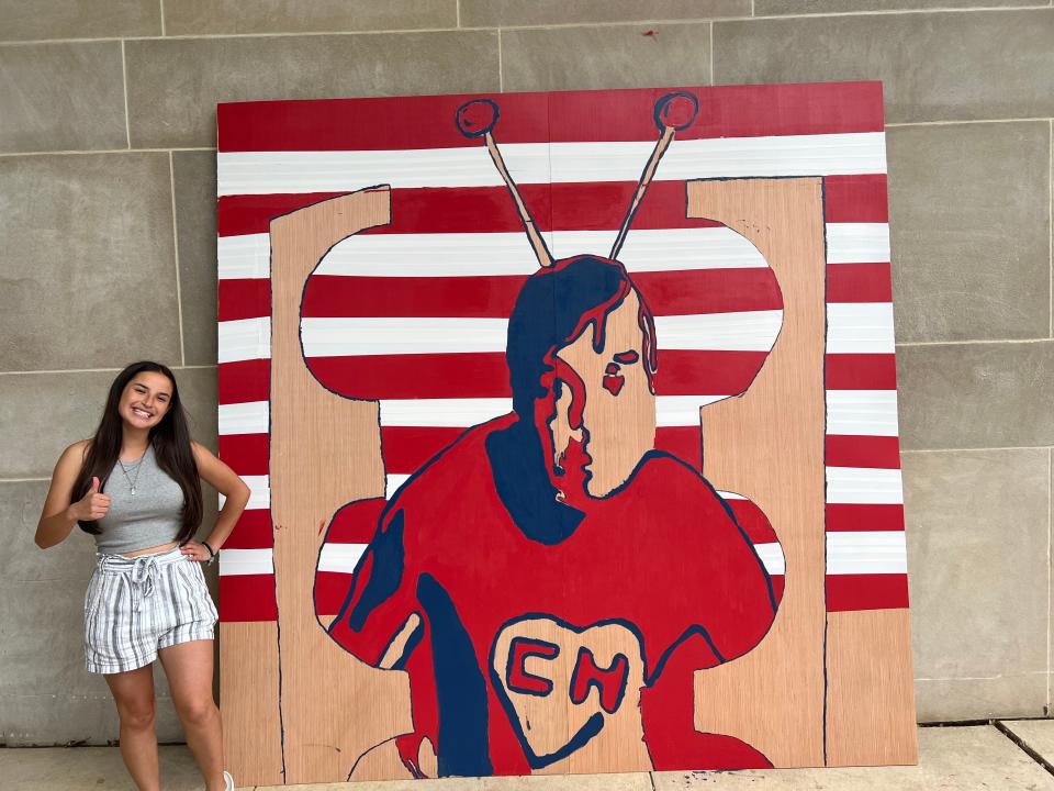 East High School student Melissa Perez, 16, poses with the El Chapulín Colorado mural on May 20, 2022.