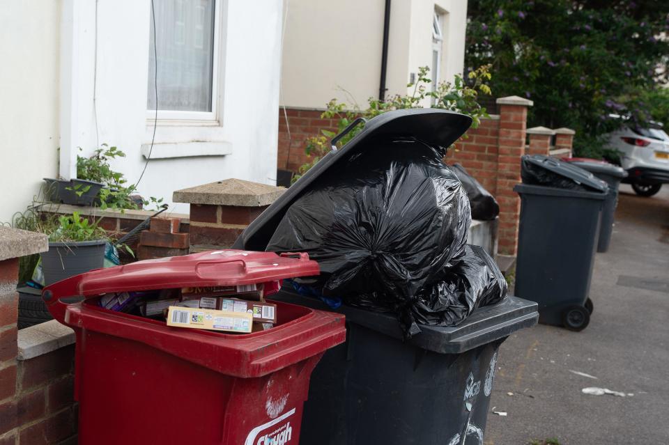 Slough, Berkshire, UK. August 3, 2023. Overflowing bins and black bin bags outside homes in Slough, Berkshire. Slough Borough Council (SBC) recently introduced a change to residents’ bin collections to encourage residents to recycle more. Grey bins for general waste, including food, will now be collected fortnightly instead of weekly, with red bin recycling being collected every other week. Some Slough residents are now reporting problems with maggots and odours from uncollected rubbish left on the streets, which is only likely to get worse as temperatures rise