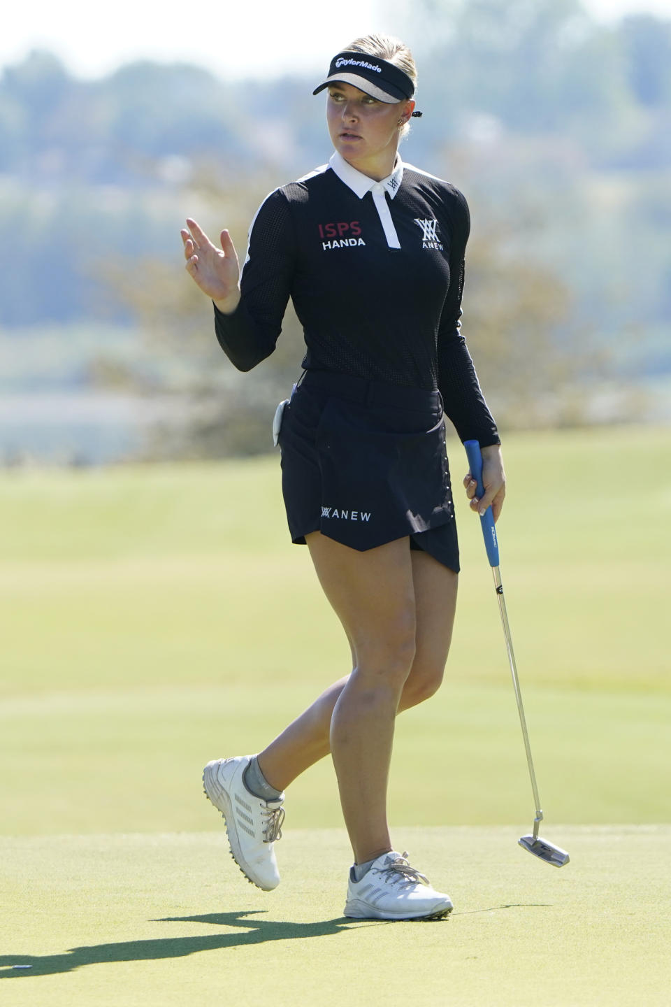 Charley Hull, of England, waves after sinking a putt on the sixth green during the final round of the LPGA The Ascendant golf tournament in The Colony, Texas, Sunday, Oct. 2, 2022. (AP Photo/LM Otero)