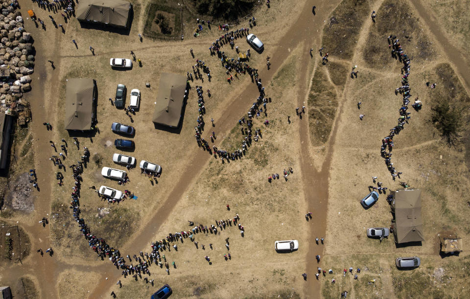 FILE - In this Monday, July 30, 2018 file photo people wait in a queue to cast their vote at a polling station in Harare, Zimbabwe. Zimbabweans on Monday voted in their first election without Robert Mugabe on the ballot, a contest that could bring international legitimacy and investment or signal more stagnation if the vote is seriously flawed. (AP Photo/Bram Janssen, File)