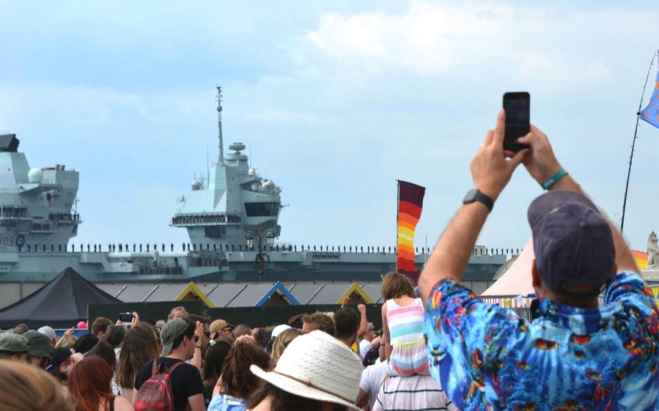 Festival goers at the Victorious Festival on Southsea Common watched as the carrier passed by (Ben Mitchell/PA) (PA Wire)