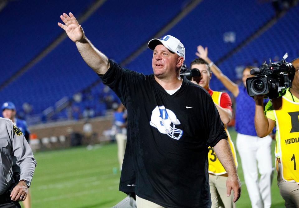 Mike Elko waves to fans after earning his first win as head coach of Duke in an NCAA college football game against Temple in Durham, N.C., Friday, Sept. 2, 2022. (AP Photo/Ben McKeown)