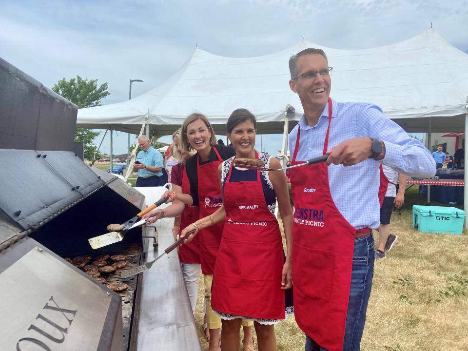 Former U.N. Ambassador Nikki Haley flips burgers with U.S. Rep. Randy Feenstra and Gov. Kim Reynolds at a Sioux Center fundraiser.