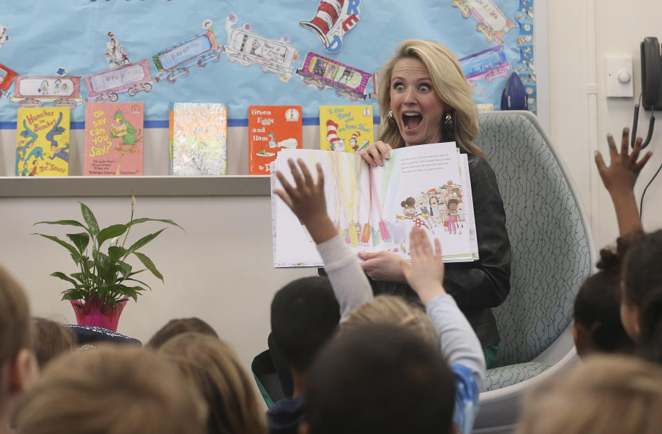 FILE-- In this March 1, 2019 file photo first partner, Jennifer Siebel Newsom, the wife of Gov. Gavin Newsom, reads the book "Ada Twist, Scientist" by Andrea Beaty and David Roberts, to kindergarteners at the Washington Elementary School in Sacramento, Calif. Siebel Newsom visited the school, with her husband to celebrate Read Across America Day. She often attends events with her husband but also works on issues of her own including equal rights for women. (AP Photo/Rich Pedroncelli, File)