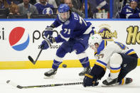 Tampa Bay Lightning center Anthony Cirelli (71) flips the puck past St. Louis Blues defenseman Torey Krug (47) during the second period of an NHL hockey game Thursday, Dec. 2, 2021, in Tampa, Fla. (AP Photo/Chris O'Meara)