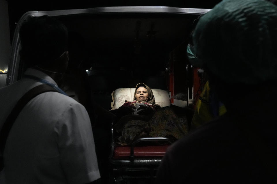 A woman injured in an earthquake lies inside an ambulance upon arrival at a hospital in Cianjur, Indonesia late Monday, Nov. 21, 2022. Rescuers on Tuesday struggled to find more bodies from the rubble of homes and buildings toppled by the earthquake that killed a number of people and injured hundreds on Indonesia's main island of Java. (AP Photo/Tatan Syuflana)